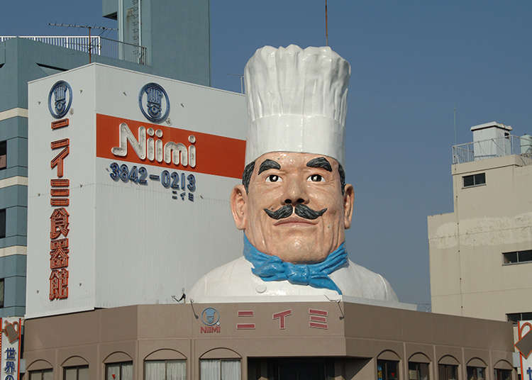 A restaurant supply store with a giant statue of a cook as its landmark